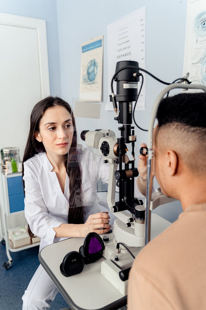 services-01 Optometrist examines patient using slit lamp for eye health assessment. Indoors clinic setting.
